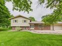 Inviting home exterior with a blend of brick and siding, complemented by a green lawn at 5542 N Olivia Dr, Alexandria, IN 46001