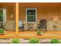 Charming front porch featuring comfortable rocking chairs and decorative flower pots at 5730 S 50 W, Trafalgar, IN 46181