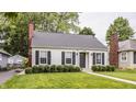 Well-maintained home with a brick chimney, nice landscaping, and a cozy, inviting curb appeal at 6040 Crittenden Ave, Indianapolis, IN 46220