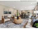 Open-concept living room, seamlessly connects with a dining area and a well-appointed kitchen at 6049 Madera Dr, Whitestown, IN 46075