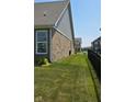 A spacious side yard with lush green grass between the homes at 6184 Farlin Dr, Whitestown, IN 46075