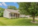 Well-maintained home with manicured lawn, mature tree, vinyl siding and brick accents adding curb appeal at 6369 Clary Ln, Greenwood, IN 46143