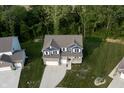 Aerial view of a two-story home surrounded by lush greenery and a well-maintained lawn at 6377 Harvey Dr, Plainfield, IN 46168
