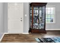 Interior entryway featuring a white door and display cabinet with shelves at 6645 Honeysuckle Way, Pendleton, IN 46064