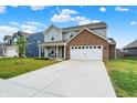 Inviting two-story home with a long driveway and manicured lawn at 6645 Honeysuckle Way, Pendleton, IN 46064