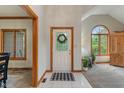Bright foyer with white tile flooring and a decorative front door at 7141 Ember Ct, Indianapolis, IN 46236