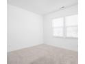 Bright, carpeted bedroom with two windows providing natural light and neutral tones throughout at 7431 Stillness Dr, Indianapolis, IN 46268