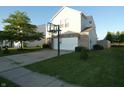 View of the front of the home with a driveway, lawn, mature tree, vinyl siding, and a basketball hoop at 8609 Wheatfield Dr, Camby, IN 46113