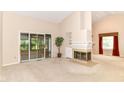 Living room with large windows, a fireplace and a door leading to a sunroom at 8713 Champions Dr, Indianapolis, IN 46256