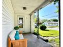 Inviting front porch with seating, decorative pillars, and a view of the neighborhood at 901 Columbia Ave, Alexandria, IN 46001