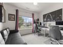 Bright home office with a large window, providing a comfortable and productive workspace at 998 Cherry Tree Ln, Greenwood, IN 46143