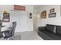 The carpeted home office with closet and a comfortable seating area at 998 Cherry Tree Ln, Greenwood, IN 46143