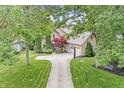 Aerial view of the lovely two-story brick home with beautiful landscaping and an attached three car garage at 10697 Woodmont Ln, Fishers, IN 46037