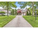 The property features a well-manicured lawn and beautiful landscaping, enhancing its curb appeal at 10697 Woodmont Ln, Fishers, IN 46037