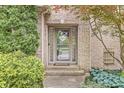 The home features a charming front entrance with a decorative glass door and lovely landscaping at 10697 Woodmont Ln, Fishers, IN 46037