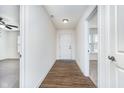 Inviting foyer with wood flooring leads to the living spaces and bedrooms at 107 Elliott Ave, Trafalgar, IN 46181