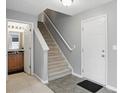 Bright entryway featuring tile floors, neutral paint, and stairs to the upper level at 10722 Landsbrook N Run, Noblesville, IN 46060