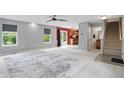 Open-concept living room with neutral walls, plush carpet, and lots of natural light at 10722 Landsbrook N Run, Noblesville, IN 46060