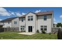 Rear exterior of the home showing vinyl siding, windows, sliding glass door, and green lawn at 1129 Central Park S Blvd, Greenwood, IN 46143