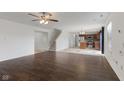 Open-concept living room with hardwood floors leading into an eat-in kitchen with an island at 11531 Short Iron Ln, Indianapolis, IN 46235