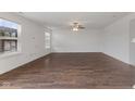 Bright, spacious living room with large windows and hardwood floors, offering ample natural light at 11531 Short Iron Ln, Indianapolis, IN 46235