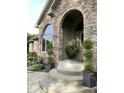 Charming front entrance with stone steps, manicured plants, and lantern-style lights at 12231 Valley View Cir, Indianapolis, IN 46229