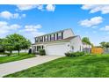 Home featuring a well-kept lawn, classic white siding, black shutters, and an attached two-car garage at 1234 Breaside Cir, Greenwood, IN 46143