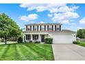 Two-story home with a well-kept lawn, classic white siding, black shutters, and an attached two-car garage at 1234 Breaside Cir, Greenwood, IN 46143