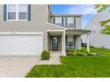 Attractive home with a cozy porch area, a well-kept lawn and a two-car garage at 12444 Bearsdale Dr, Indianapolis, IN 46235