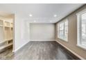 An airy living room showcases gray hardwood flooring and recessed lighting throughout at 13050 Grand Vue Dr, Carmel, IN 46032