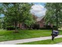 Charming red brick home with well-kept lawn, showcasing classic architecture and curb appeal at 13693 Cunningham Dr, Carmel, IN 46074