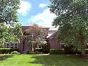 Gorgeous brick home surrounded by lush greenery, highlighting its elegant architecture and landscaping at 13693 Cunningham Dr, Carmel, IN 46074