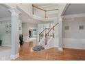 Elegant foyer boasts hardwood floors, staircase, and second-floor balcony, creating an open and inviting entrance at 13693 Cunningham Dr, Carmel, IN 46074