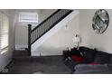 Cozy living room featuring staircase, comfortable seating, and stylish decor at 1619 Kessler Blvd E Dr, Indianapolis, IN 46220