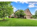 Beautiful home with lush green lawn, mature trees, and brick exterior at 1850 Longest Dr, Franklin, IN 46131