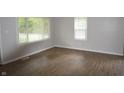 Bright bedroom with modern flooring, fresh paint, and natural light from two large windows at 1902 N Colorado Ave, Indianapolis, IN 46218