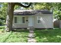 Well-maintained single-story home featuring a tidy front lawn and inviting entryway with a white front door at 1902 N Colorado Ave, Indianapolis, IN 46218