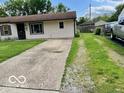 Home exterior view, showcasing the home's driveway and front lawn at 1998 Crescent St, Franklin, IN 46131
