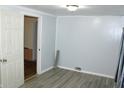 Bedroom featuring new plank flooring and painted walls with a doorway leading to another room at 202 S Church St, Brooklyn, IN 46111