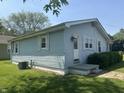 Side view of a light blue one-story home with well-placed windows and a neat lawn at 2133 10Th St, Columbus, IN 47201