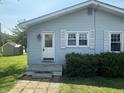 View of the front door and the side of the house with symmetrical windows and white trim at 2133 10Th St, Columbus, IN 47201