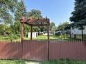 View of backyard featuring a small building and a wooden awning or entry at 2310 E Raymond St, Indianapolis, IN 46203