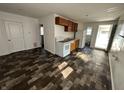 Kitchen with wood cabinets, white appliances, and faux wood floors in an open layout at 2310 E Raymond St, Indianapolis, IN 46203