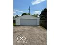Exterior shot of a detached one-car garage with white siding and an asphalt driveway at 233 N 16Th Ave, Beech Grove, IN 46107
