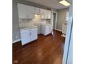 Spacious kitchen featuring hardwood floors, white cabinets, and modern countertops at 233 N 16Th Ave, Beech Grove, IN 46107