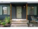 Inviting front porch with stone steps, wood pillars, and cozy seating area to enjoy at 2715 Northview Ave, Indianapolis, IN 46220