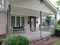 Inviting covered front porch with decorative railing and ample space for seating at 2825 Lucas Way, Columbus, IN 47203