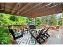 Inviting covered patio with a pergola, comfortable seating, and a stylish outdoor rug at 3295 Allison Ct, Carmel, IN 46033