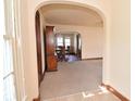 Inviting living room with hardwood floors and an arched entryway to the dining room at 341 Barton Ave, Indianapolis, IN 46241