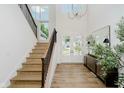 Bright foyer with hardwood floors, staircase, and double doors at 3713 Cherwell Dr, Zionsville, IN 46077